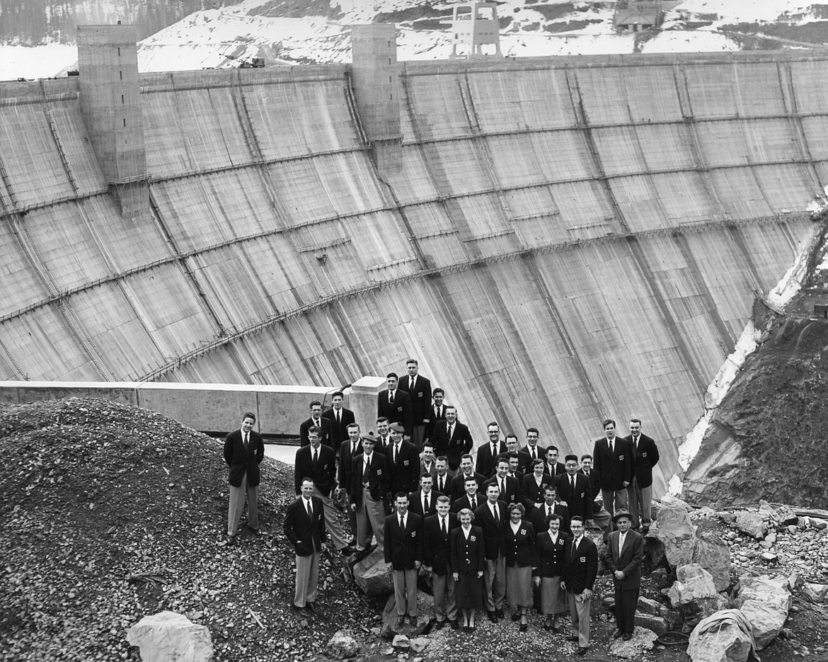 An unidentified group gathered for a commemorative photo on the overlook that gives the best view of the Hungry Horse Dam in this photo from the period while the dam was still under construction. Pouring the tons of concrete that created the huge hydroelectric dam was a source of work for hundreds, if not thousands, of people in the 1950s. (Bureau of Reclamation photo)