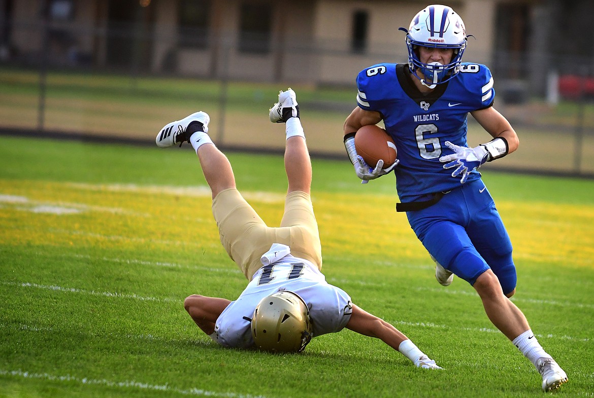 Wildcat receiver Brayden Stone gets the better of a Dillon defender during the first quarter in Columbia Falls Friday. The Cats downed the Beavers, 48-20. (Jeremy Weber photo)