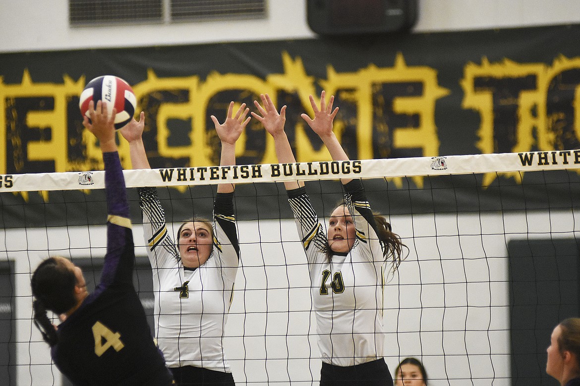 Lucy Ridgeway and Kaiah Moore rise up to block a Polson spike at the net during last Tuesday&#146;s sweep of the Lady Pirates at home.