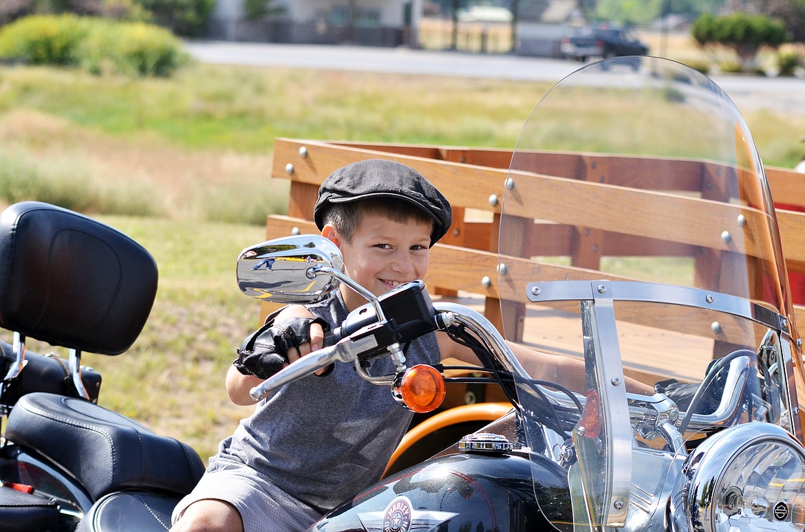 Young Jayden Anderson loved getting up and close with the bikes during the car and bike show saying that the blue motorcycle was his favorite. (Erin Jusseaume/Clark Fork Valley Press)