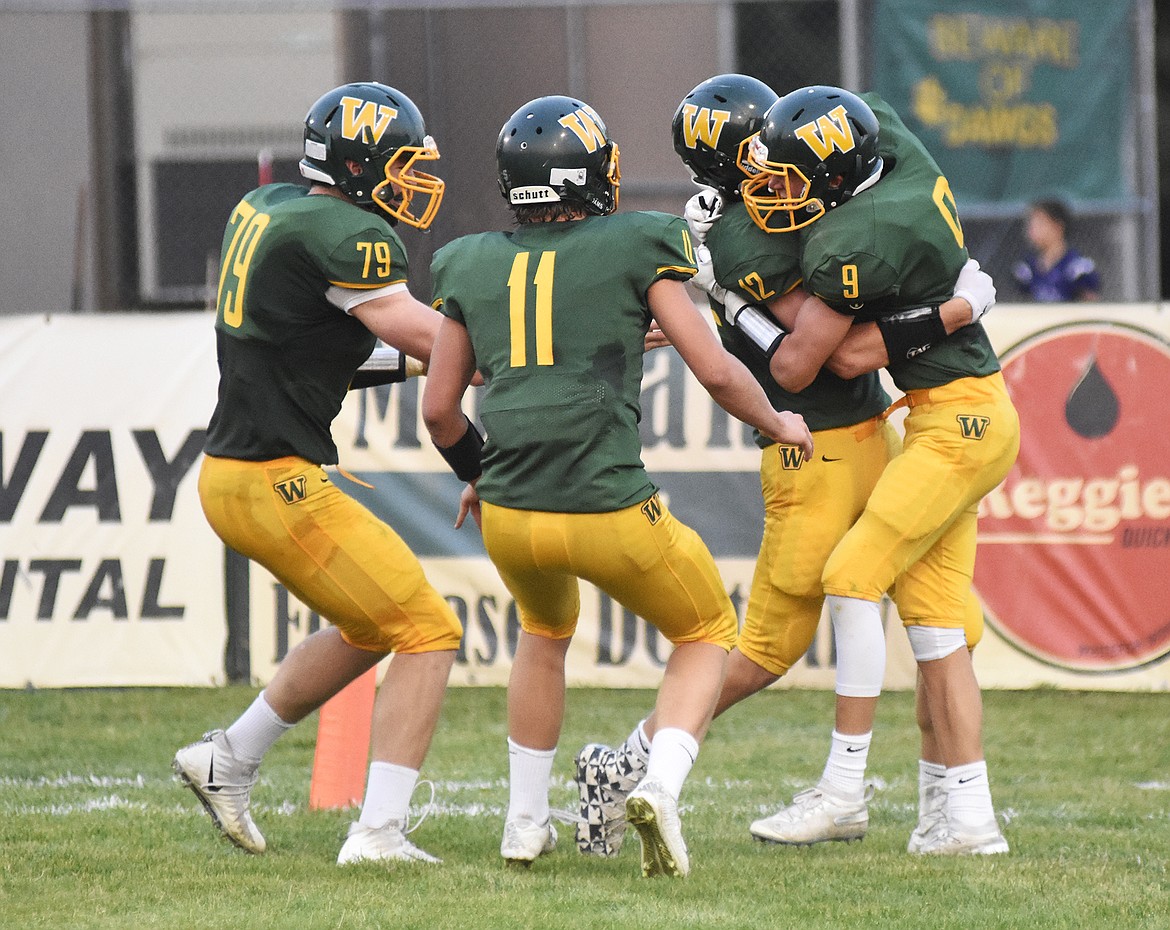 A group of Bulldogs celebrate after a touchdown during a 28-27 victory over Butte Central Friday night at Memorial Field.