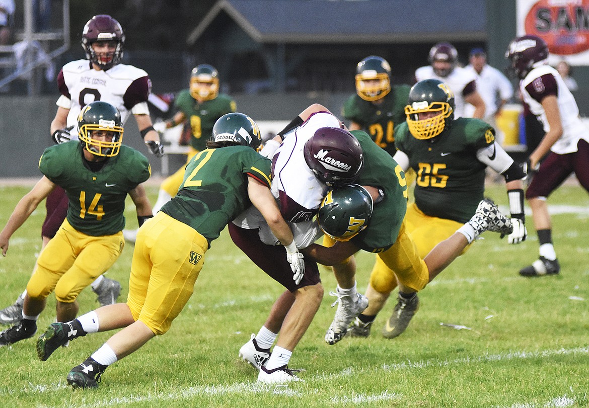 The Bulldogs defense swarms a Butte Central player during a 28-27 victory Friday night at Memorial Field.