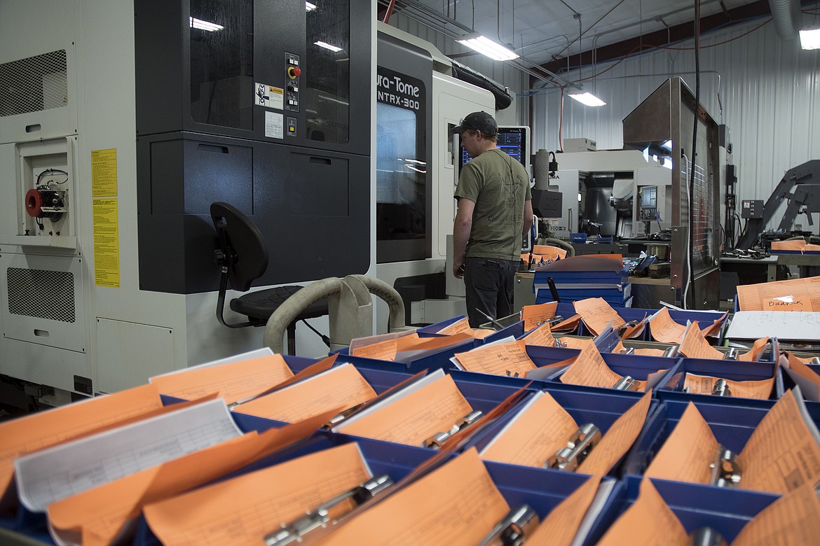 Defiance Machine employee Logan Chamberlain keeps a close eye on the production of an order. (Jeremy Weber photo)