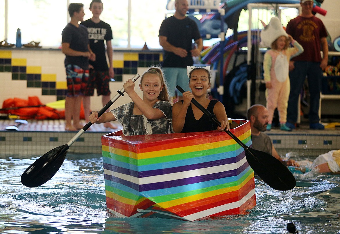 Woodland Middle School eighth-graders Ashlynn Sullivan, left, and Amya Sines compete in the sixth annual cardboard boat race at Kootenai Health&#146;s McGrane Center pool. (LOREN BENOIT/Press)