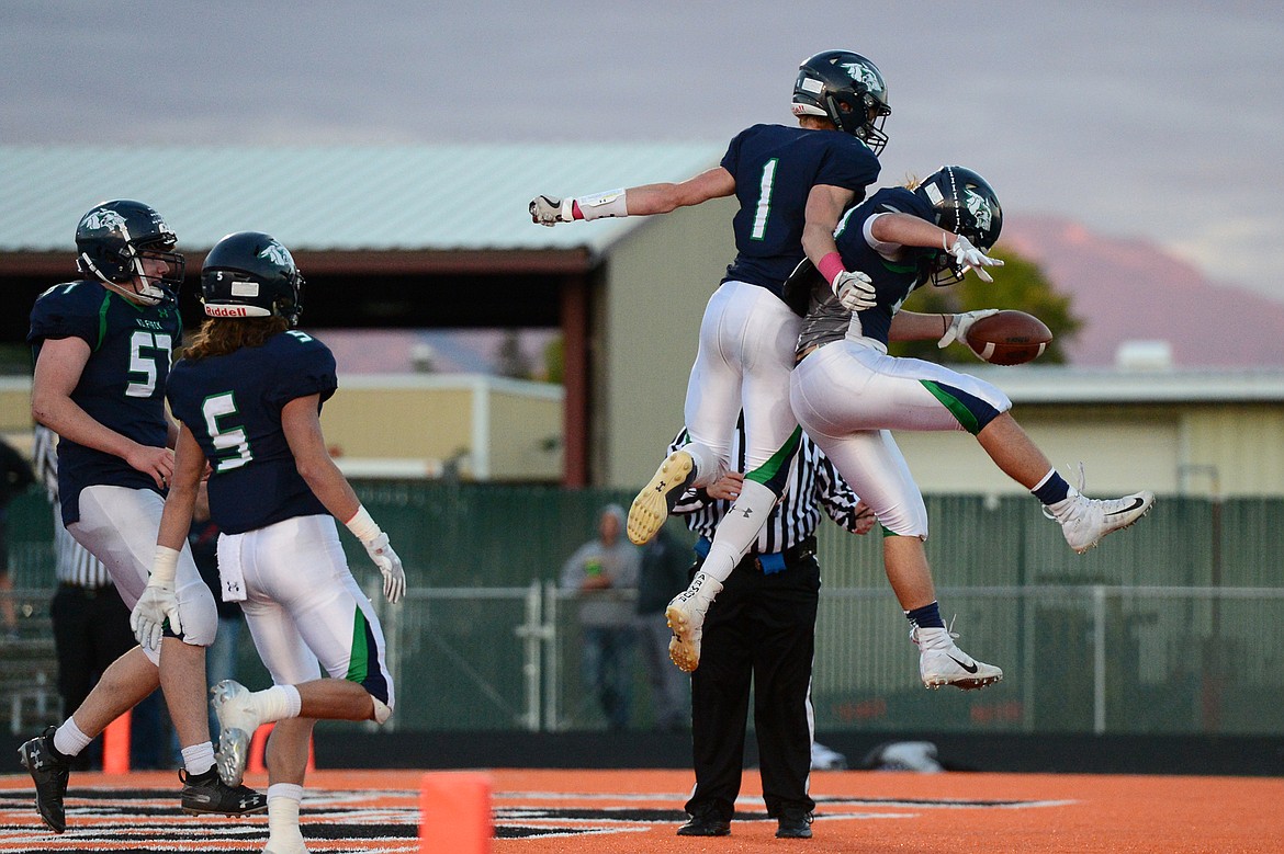 Glacier's Colin Bowden (1) and Preston Blain (33) celebrate in the end zone after Blain's first-quarter touchdown run against Missoula Sentinel at Legends Stadium on Friday. (Casey Kreider/Daily Inter Lake)