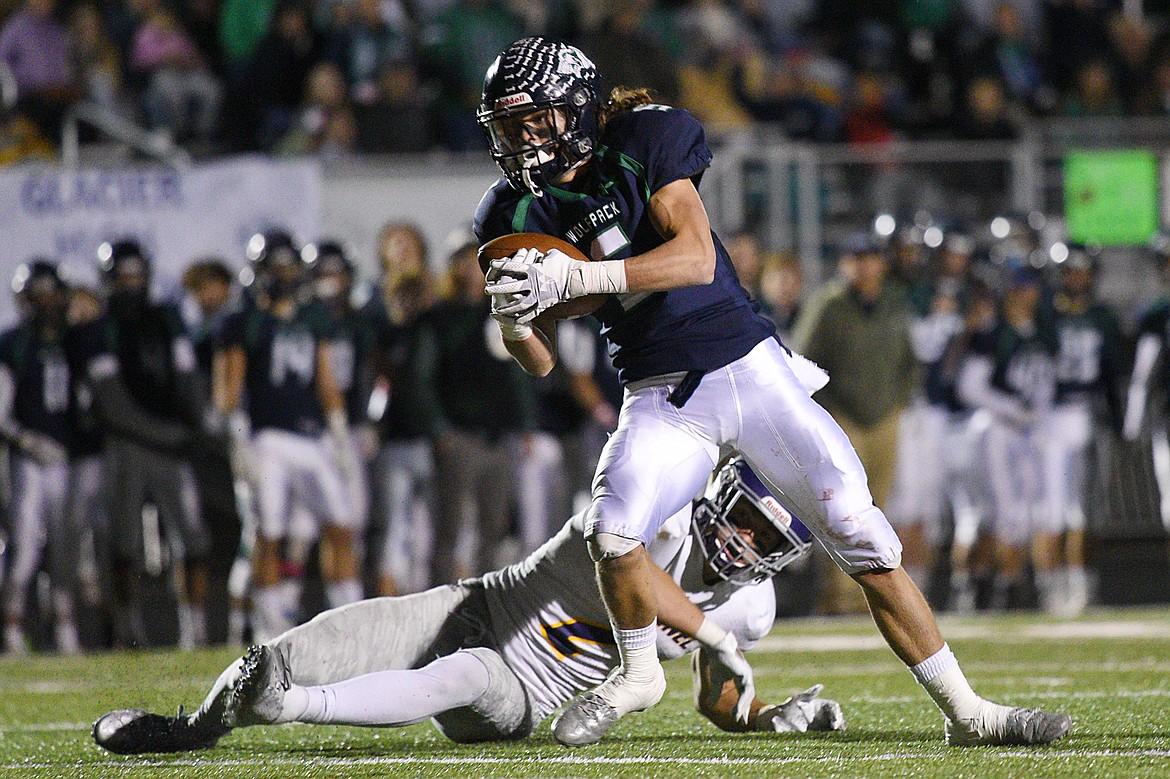 Glacier wide receiver Drew Deck (5) catches a 24-yard touchdown reception in the fourth quarter against Missoula Sentinel defensive back Rylan Ortt (2) to tie the game at 28-28 at Legends Stadium on Friday. (Casey Kreider/Daily Inter Lake)