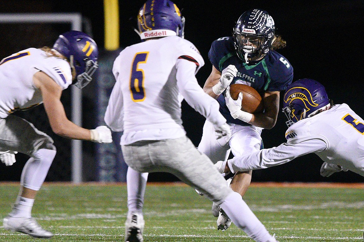 Glacier wide receiver Drew Deck (5) is surrounded by Missoula Sentinel defenders after a third quarter reception at Legends Stadium on Friday. (Casey Kreider/Daily Inter Lake)