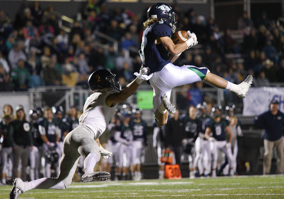 Glacier wide receiver Drew Deck (5) catches a 24-yard touchdown reception in the fourth quarter against Missoula Sentinel defensive back Rylan Ortt (2) to tie the game at 28-28 at Legends Stadium on Friday. (Casey Kreider/Daily Inter Lake)