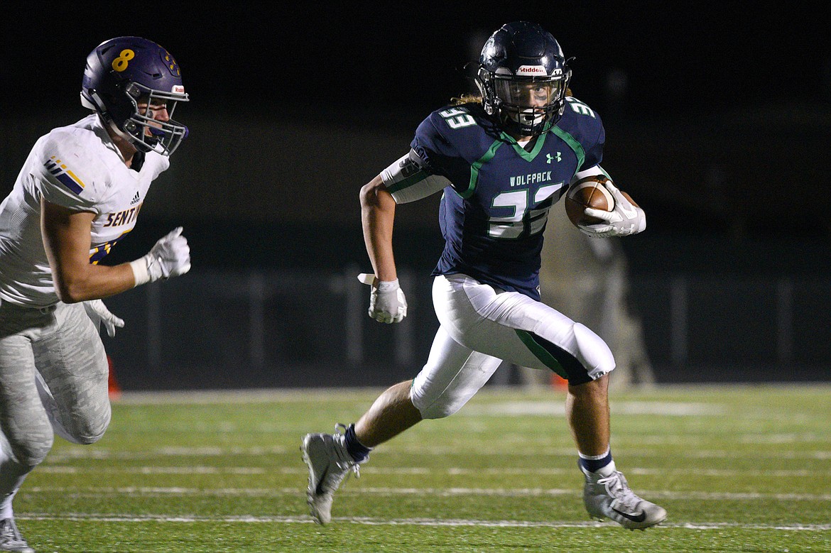 Glacier running back Preston Blain (33) looks to turn the corner against Missoula Sentinel's Blaise Meriwether (8) in the third quarter at Legends Stadium. (Casey Kreider/Daily Inter Lake)