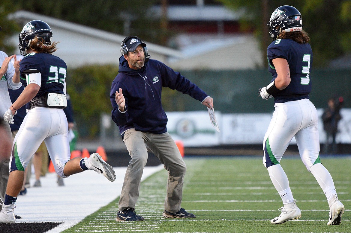 Glacier head coach Grady Bennett congratulates Preston Blain (33) and Danny Anderson (3) after a first half touchdown against Missoula Sentinel at Legends Stadium on Friday. (Casey Kreider/Daily Inter Lake)