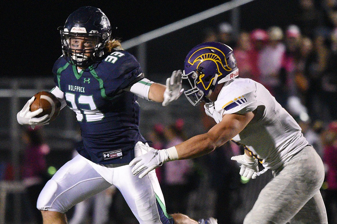 Glacier running back Preston Blain (33) stiff-arms Missoula Sentinel defensive back Blaise Meriwether (8) on a third quarter run at Legends Stadium on Friday. (Casey Kreider/Daily Inter Lake)