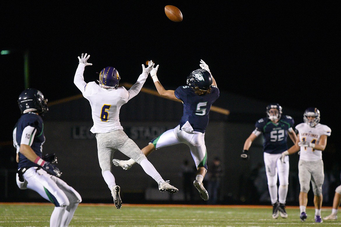 Glacier wide receiver Drew Deck (5) and Missoula Sentinel defensive back Brendon Hill (6) vie for a tipped pass in the third quarter at Legends Stadium on Friday. The pass was intercepted by Missoula Sentinel. (Casey Kreider/Daily Inter Lake)