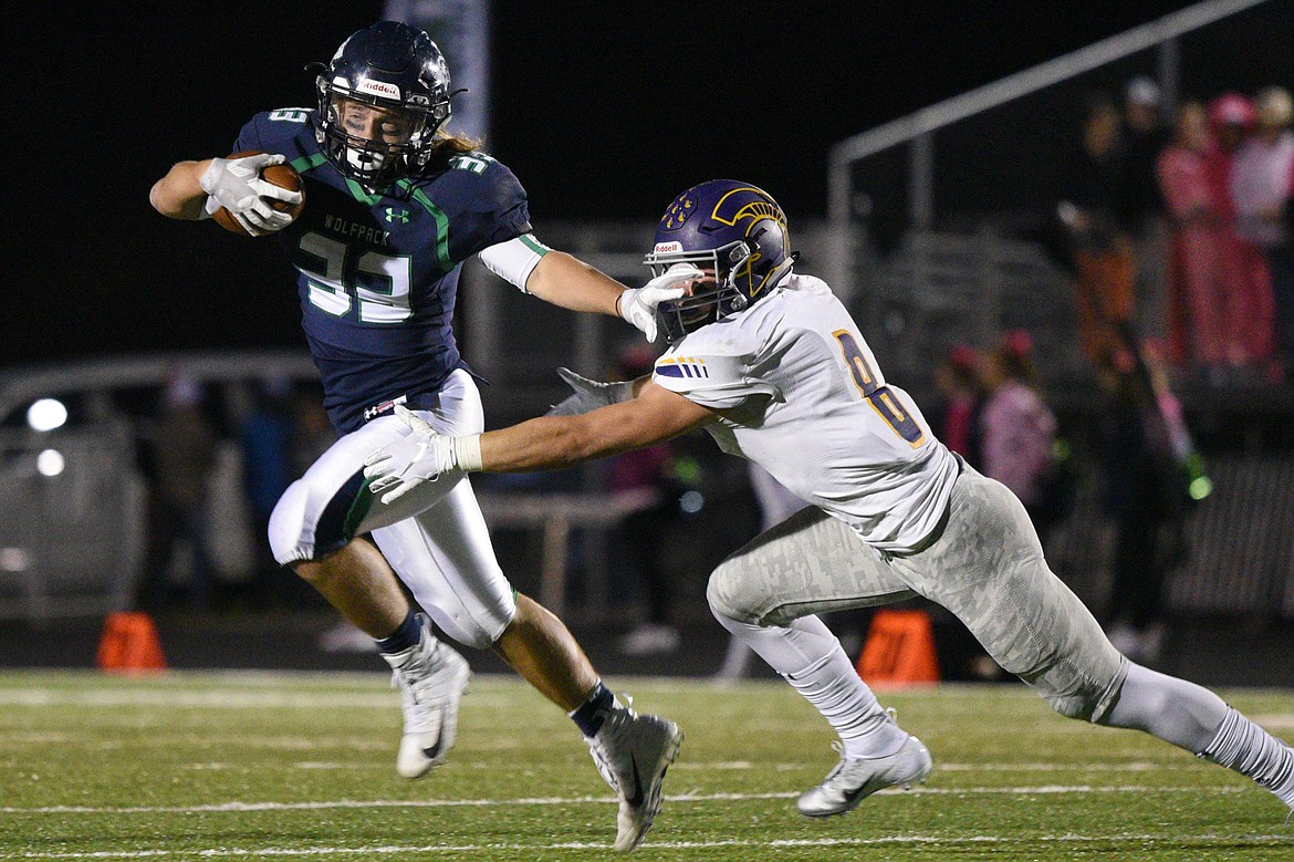 Glacier running back Preston Blain (33) stiff-arms Missoula Sentinel defensive back Blaise Meriwether (8) on a third quarter run at Legends Stadium on Friday. (Casey Kreider/Daily Inter Lake)