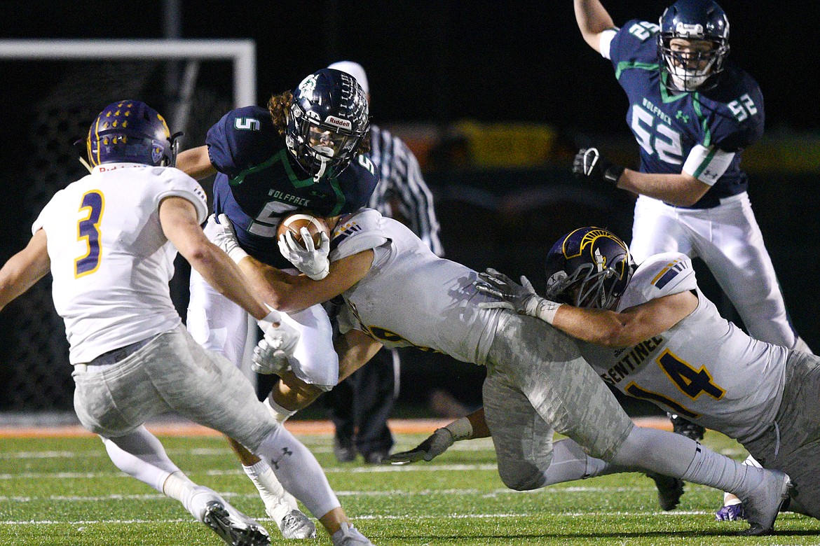 Glacier wide receiver Drew Deck (5) is brought down by a host of Missoula Sentinel defenders after a first half reception at Legends Stadium on Friday. (Casey Kreider/Daily Inter Lake)