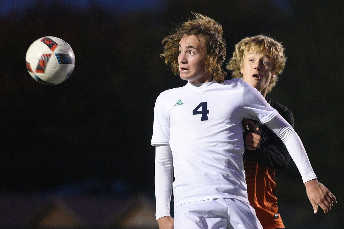 Glacier's Braden Nitschelm (4) battles Flathead's Jalen Hawes (7) for a header in the second half of a crosstown matchup at Legends Stadium on Thursday. (Casey Kreider/Daily Inter Lake)