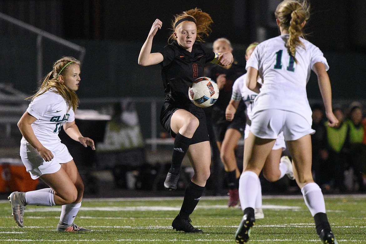 Flathead's Skyleigh Thompson (9) works around a group of Glacier defenders during a crosstown matchup at Legends Stadium on Thursday. (Casey Kreider/Daily Inter Lake)