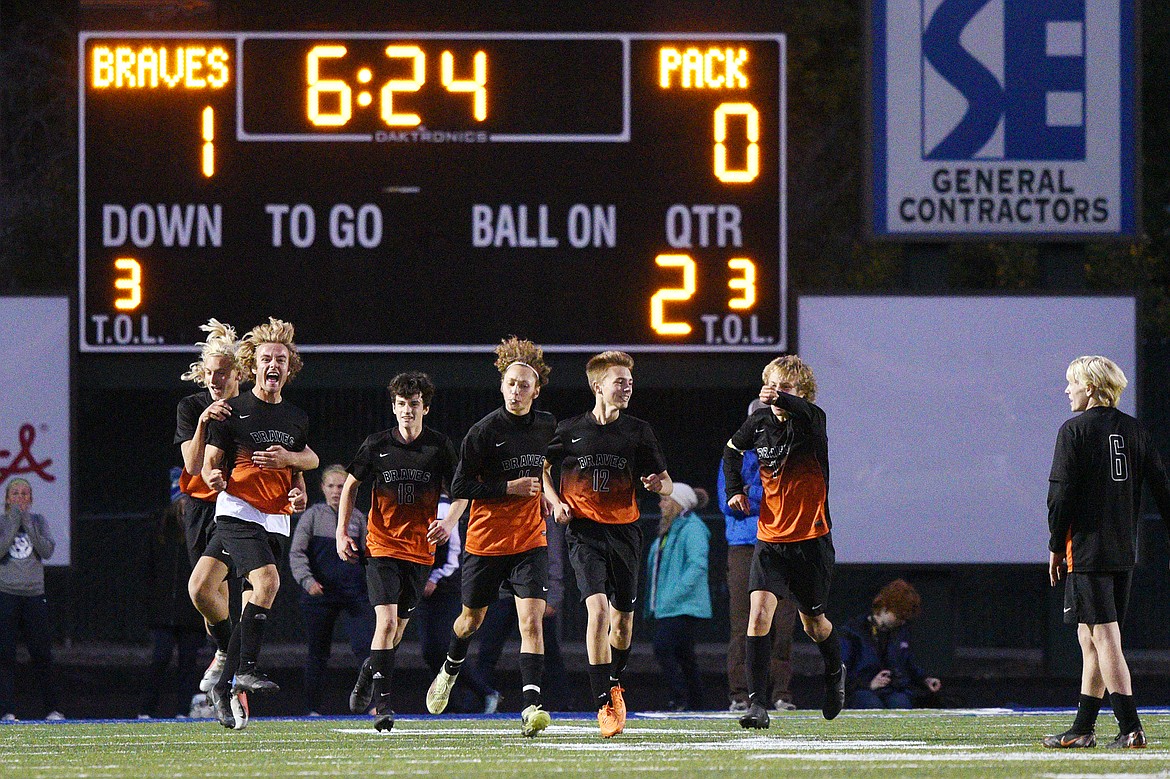 Flathead's Colter Goss (13, second from left) and Ethan Vandenbosch (21) celebrate with teammates after Goss' second-half goal against Glacier put the Braves up 2-0 in a crosstown matchup at Legends Stadium on Thursday. (Casey Kreider/Daily Inter Lake)