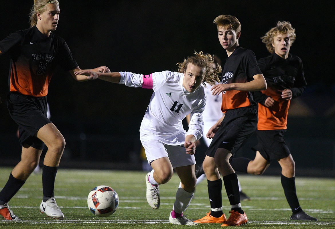 Glacier's Dyllyn Stabler (11) moves the ball upfield through Flathead defenders during a crosstown matchup at Legends Stadium on Thursday. (Casey Kreider/Daily Inter Lake)