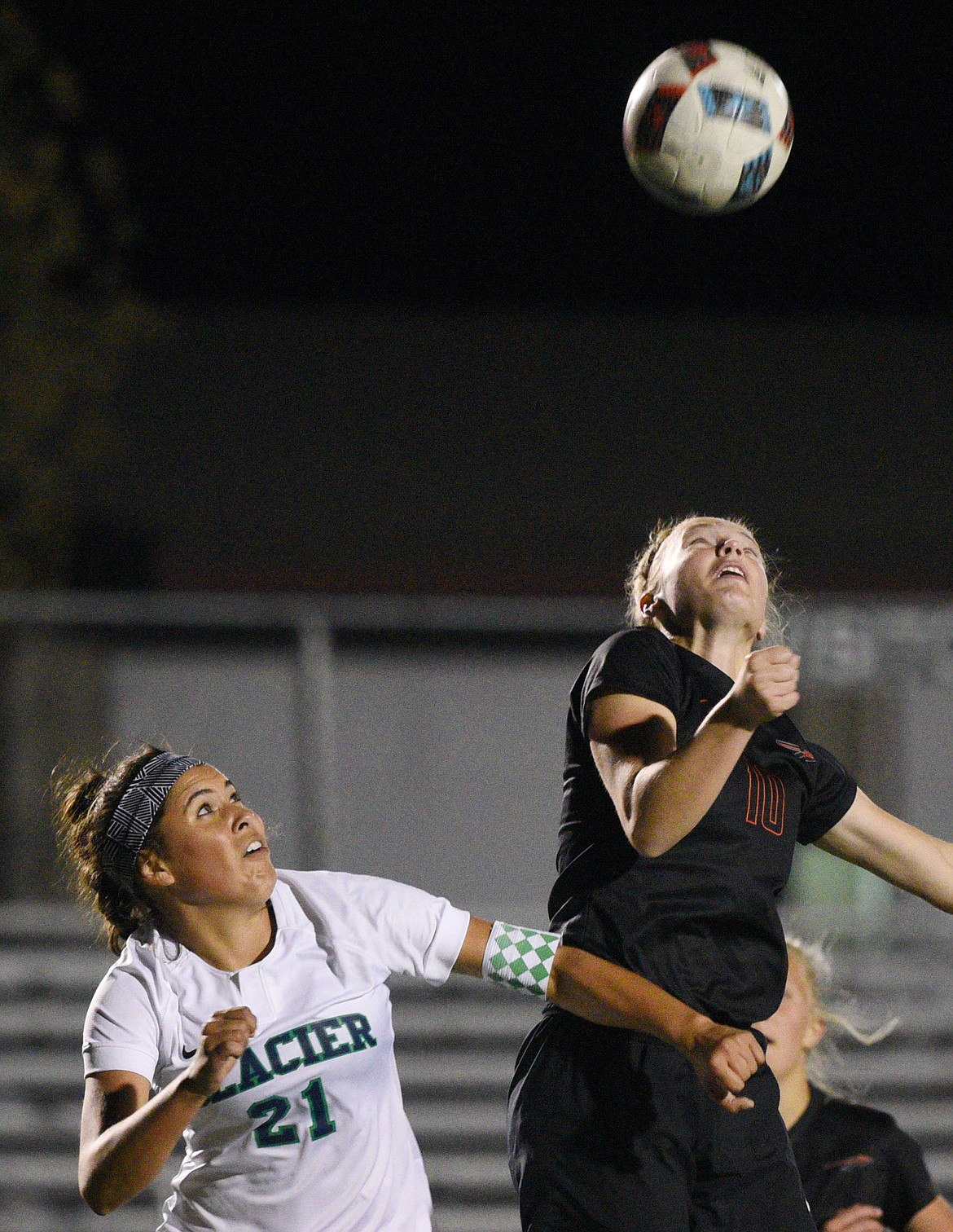 Flathead's Shayenn Thompson (10) and Glacier's Paulina Carbajal-Jepsen (21) battle for a header in front of the net during a crosstown matchup at Legends Stadium on Thursday. (Casey Kreider/Daily Inter Lake)