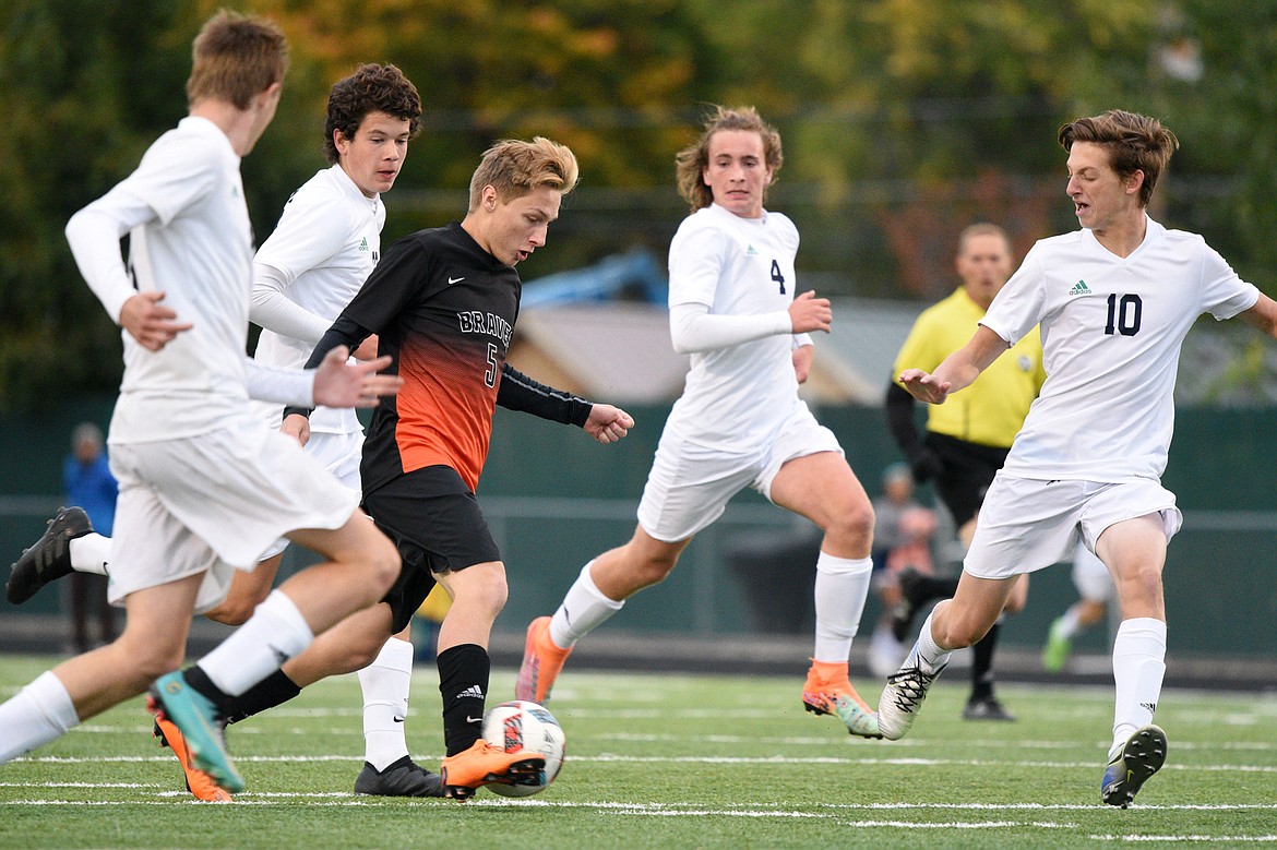 Flathead's AJ Apple dribbles through a group of Glacier defenders during a crosstown matchup at Legends Stadium on Thursday. (Casey Kreider/Daily Inter Lake)