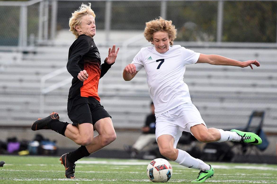 Flathead's Eric Gardner (6) and Glacier's Micah Heil (7) battle for possession in the first half of a crosstown matchup at Legends Stadium on Thursday. (Casey Kreider/Daily Inter Lake)