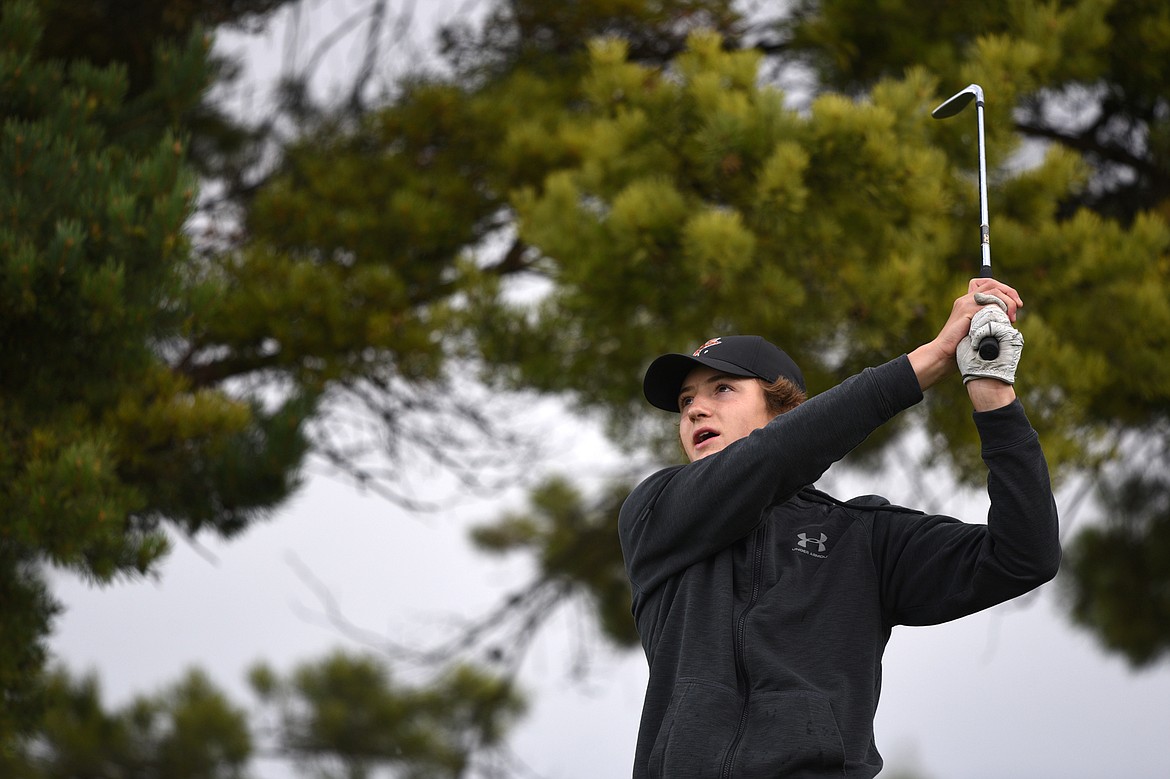 Flathead's Josten Cripe watches his tee shot on the fourth hole during the Crosstown Cup at Village Greens Golf Club on Thursday. (Casey Kreider/Daily Inter Lake)