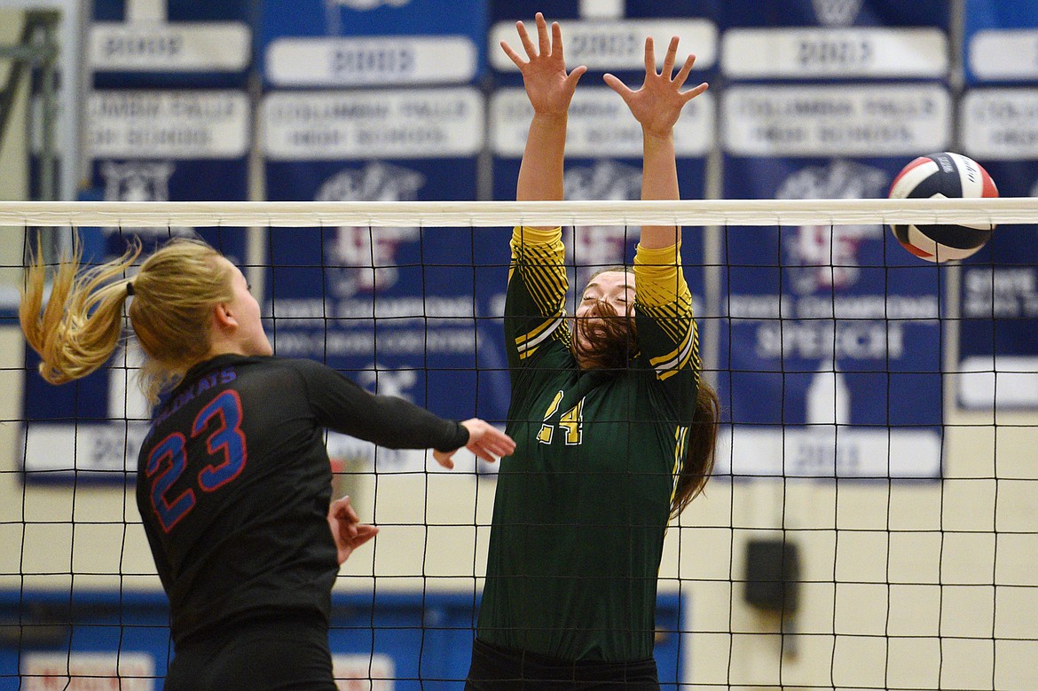 Columbia Falls' Ryley Kehr (23) gets a kill past Whitefish's Marlee Bender (24) at Columbia Falls High School on Tuesday. (Casey Kreider/Daily Inter Lake)