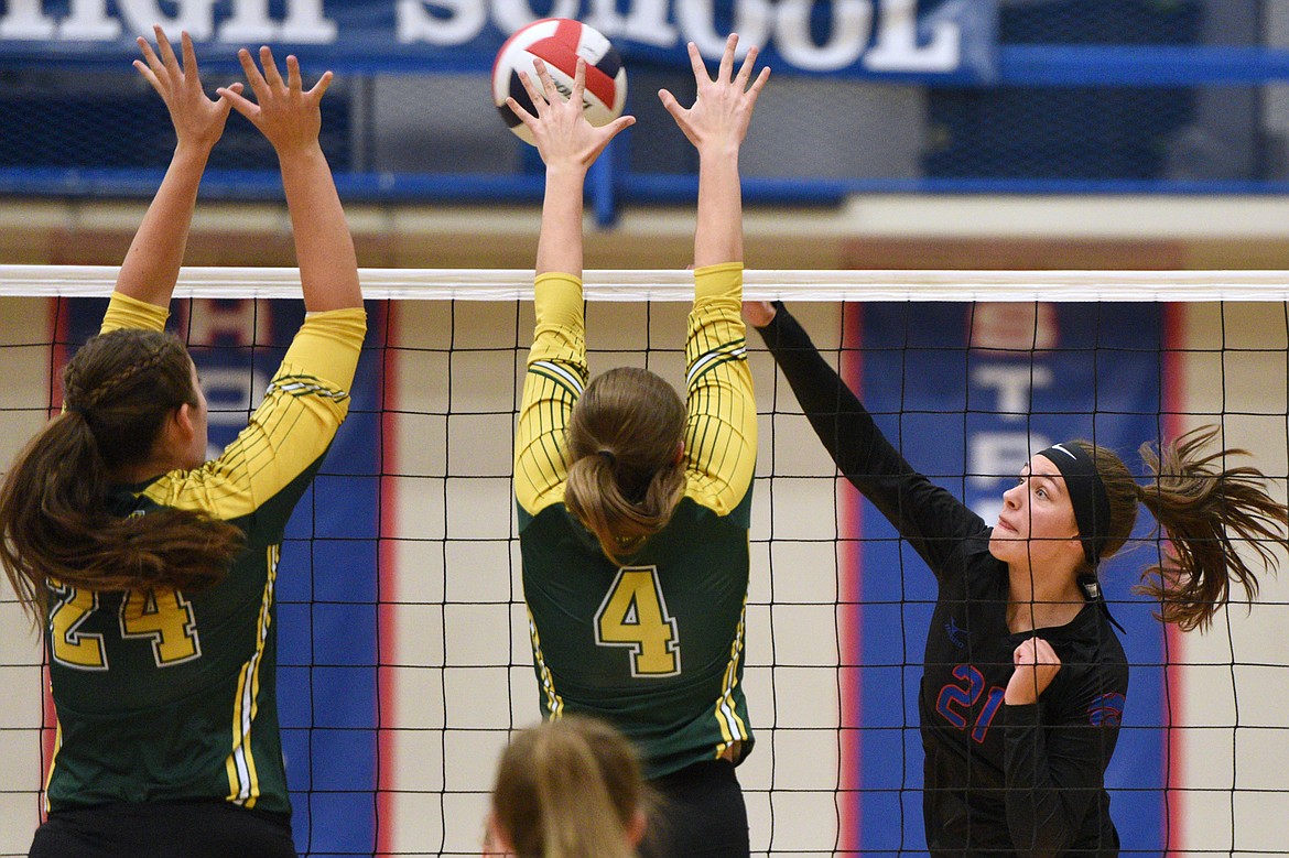 Columbia Falls' Madysen Hoerner (21) looks for a kill against Whitefish's Marlee Bender (24) and Luci Ridgeway (4) at Columbia Falls High School on Tuesday. (Casey Kreider/Daily Inter Lake)