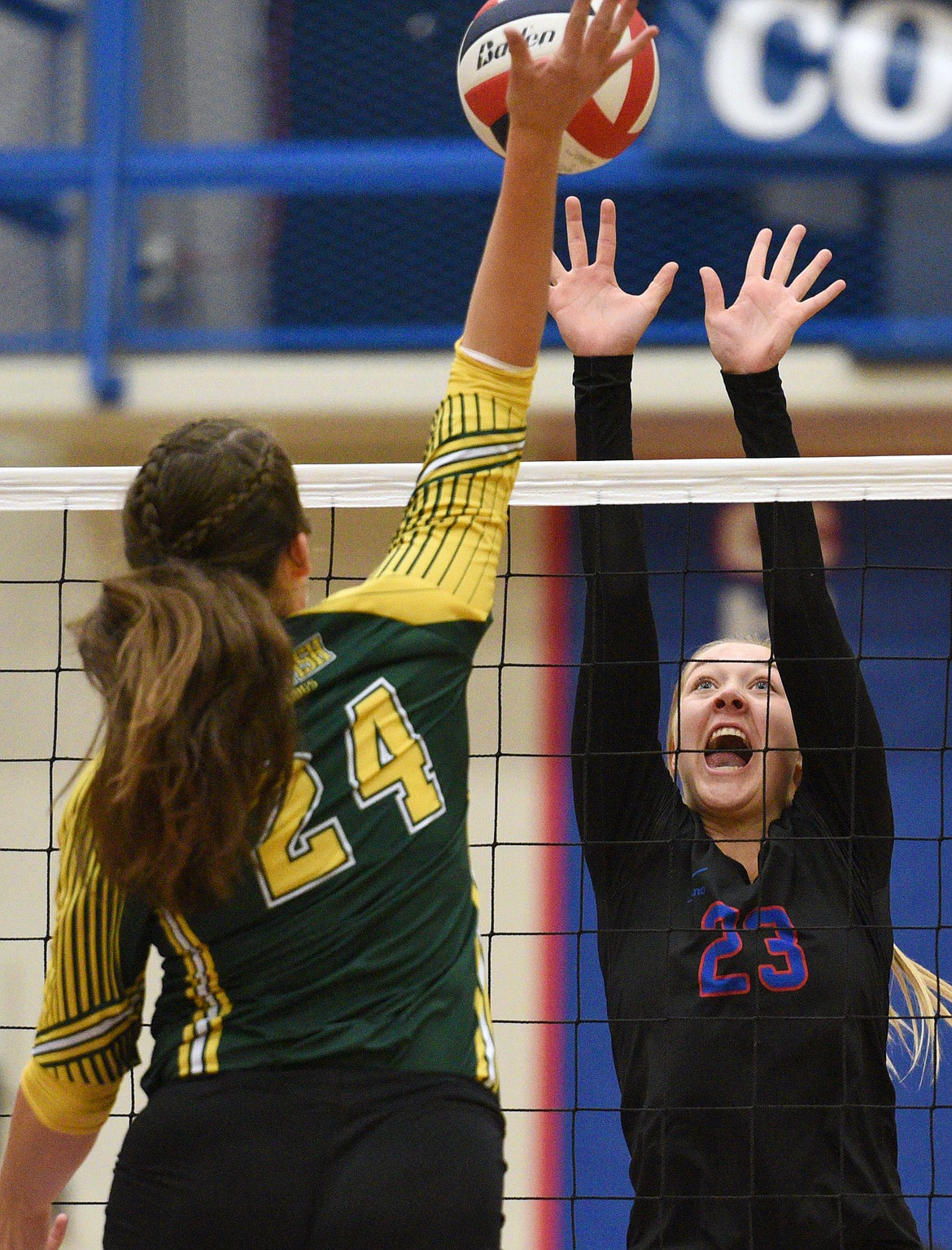 Columbia Falls' Ryley Kehr (23) looks to block a spike by Whitefish's Marlee Bender (24) at Columbia Falls High School on Tuesday. (Casey Kreider/Daily Inter Lake)