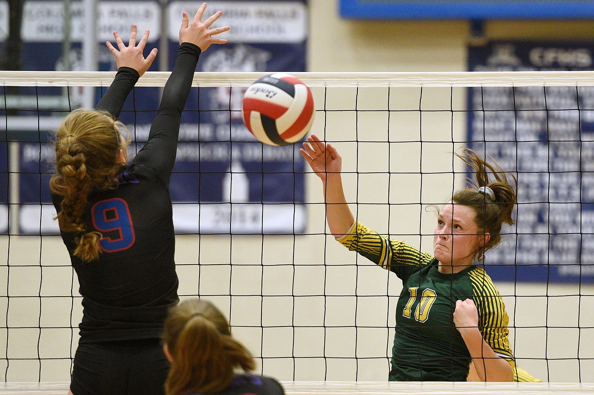 Whitefish's Kaiah Moore (10) gets a kill past Columbia Falls' Hannah Schweikert (9) at Columbia Falls High School on Tuesday. (Casey Kreider/Daily Inter Lake)