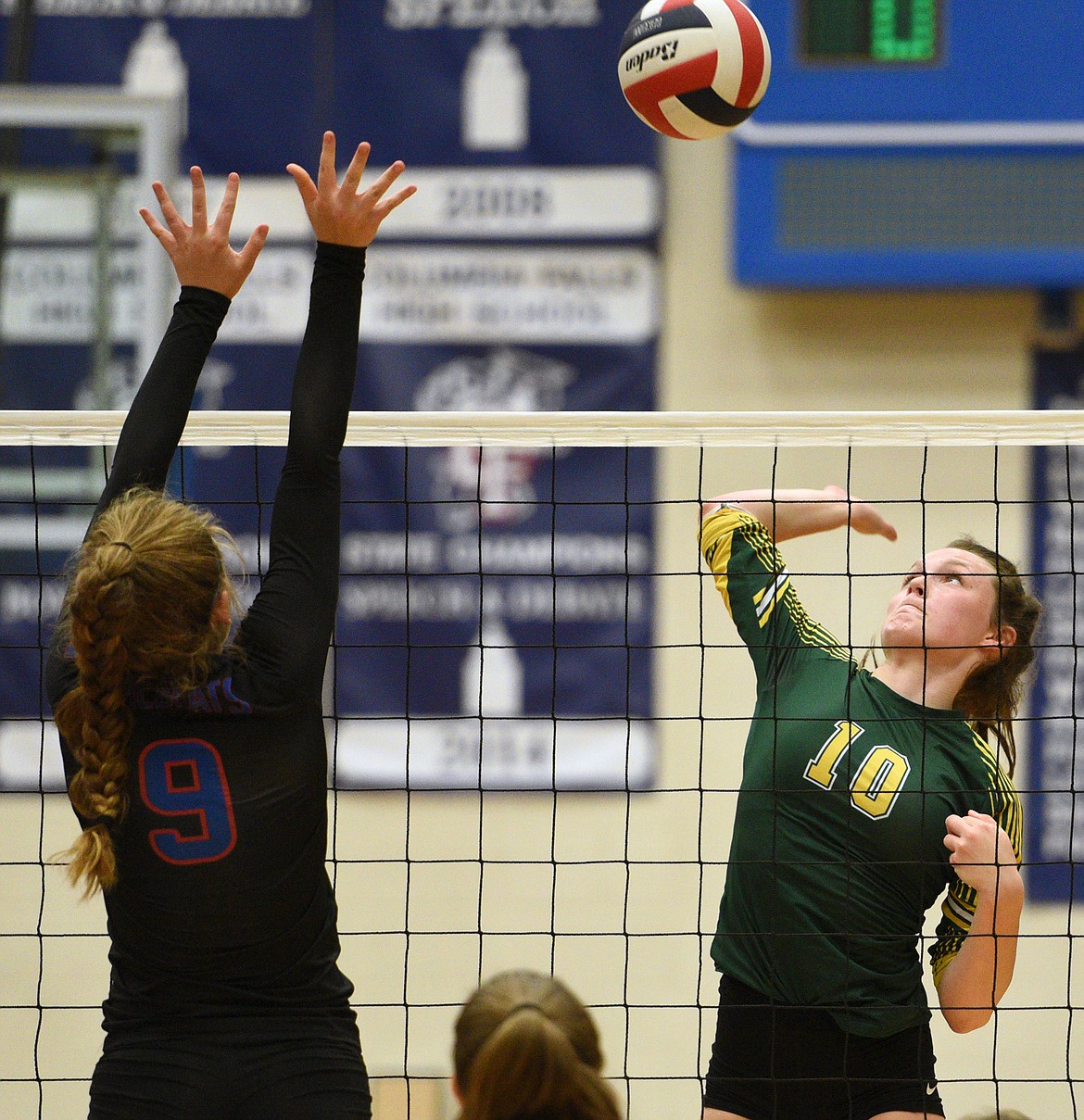 Whitefish's Kaiah Moore (10) looks for a kill against Columbia Falls' Hannah Schweikert (9) at Columbia Falls High School on Tuesday. (Casey Kreider/Daily Inter Lake)