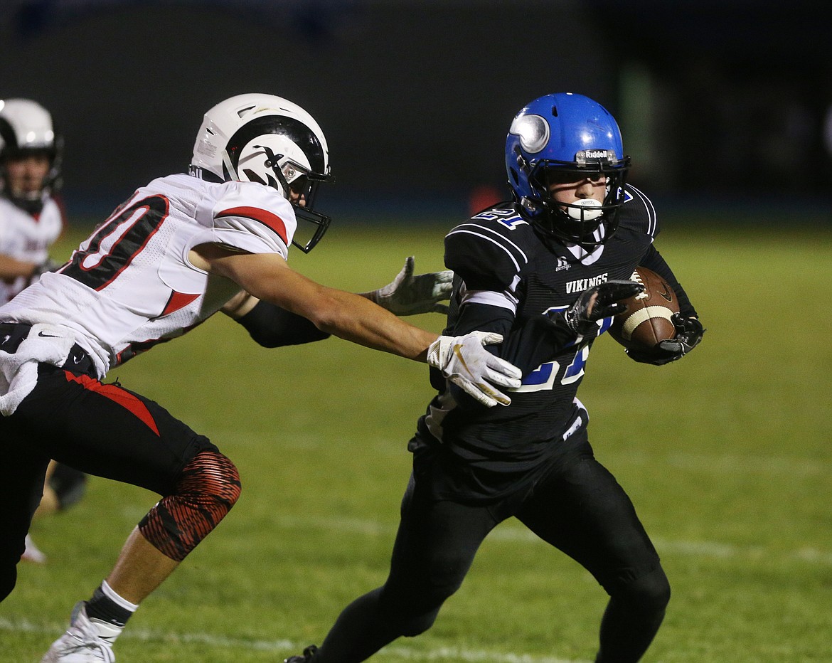 Coeur d&#146;Alene wide receiver Colbey Nosworthy runs the ball upfield by Highland defender Jadon Whitworth in Friday night&#146;s game at Coeur d&#146;Alene High. (LOREN BENOIT/Press)