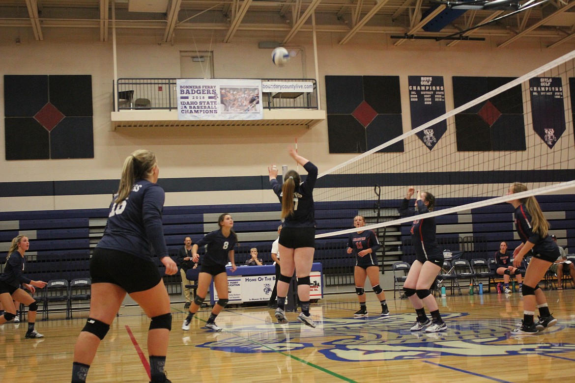 The Badgers fight for a ball at the net.