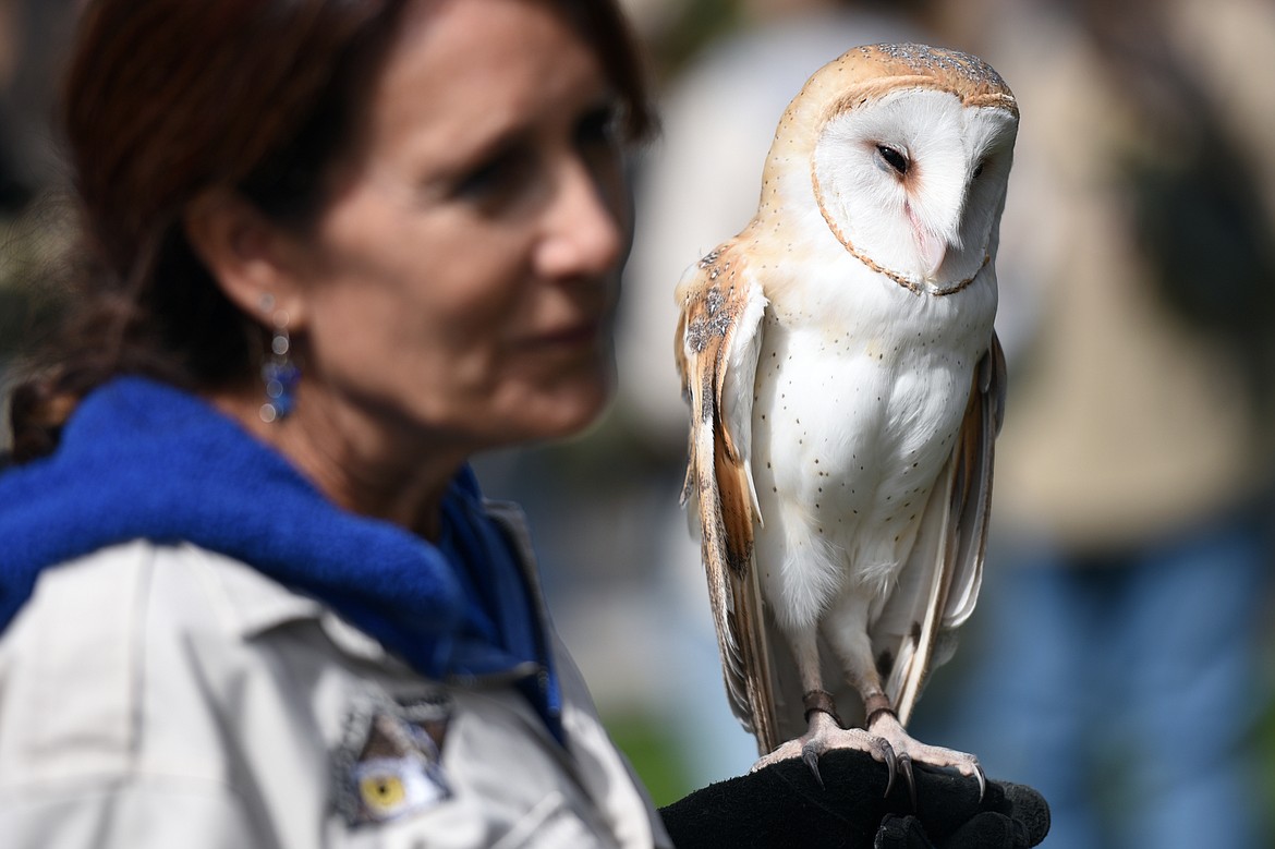 Nancy Riva, with Montana Wild Wings, speaks to visitors as she holds Igor, a barn owl, at the Birds of Prey Festival at Lone Pine State Park on Saturday. (Casey Kreider/Daily Inter Lake)