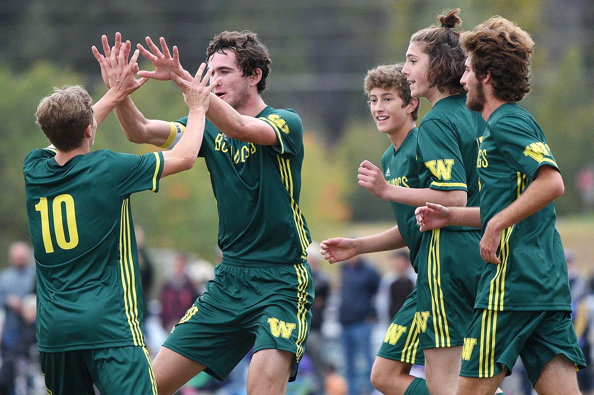 From left, Whitefish&#146;s Casey Schneider (10), Sam Menicke (20), Gabe Menicke (9), James Thompson (17) and Xander Burger (16) celebrate after Sam Menicke&#146;s first half goal off a corner kick from Schneider against Polson at Smith Fields on Saturday. (Casey Kreider/Daily Inter Lake)