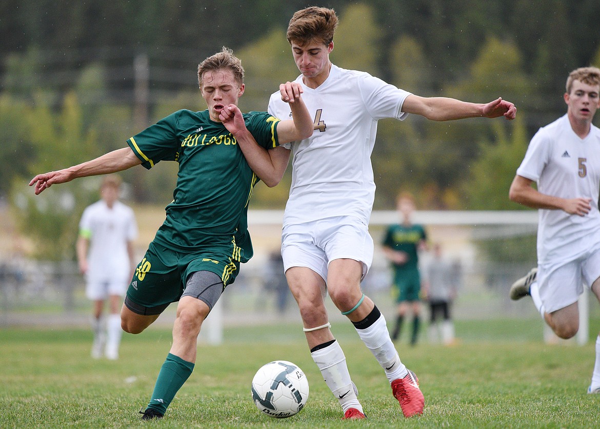 Whitefish's Casey Schneider (10) battles Polson's Davis Smith (4) for possession at Smith Fields in Whitefish on Saturday. (Casey Kreider/Daily Inter Lake)