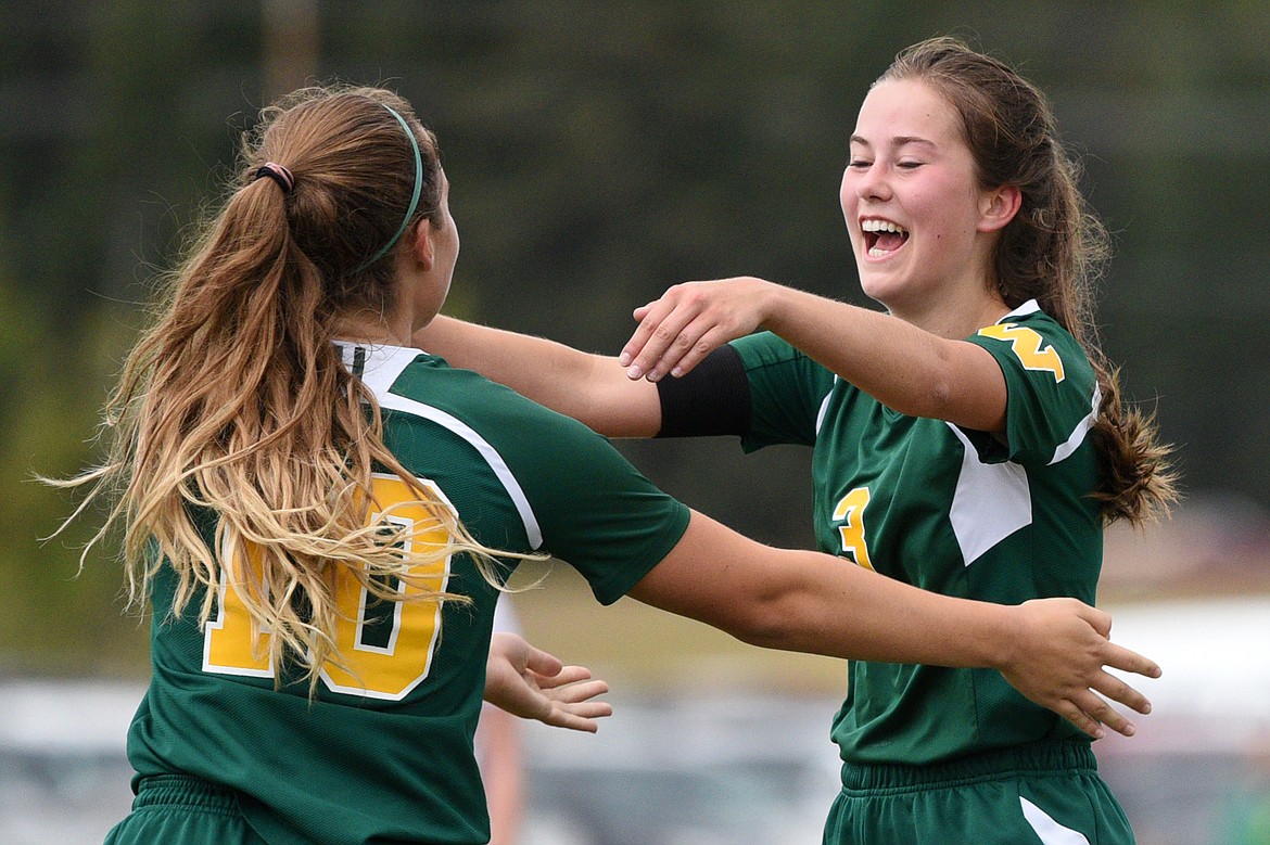 Whitefish's Ali Hirsch (10) and Grace Benkelman (3) celebrate after Hirsch's goal in the first half against Polson at Smith Fields in Whitefish on Saturday. (Casey Kreider/Daily Inter Lake)