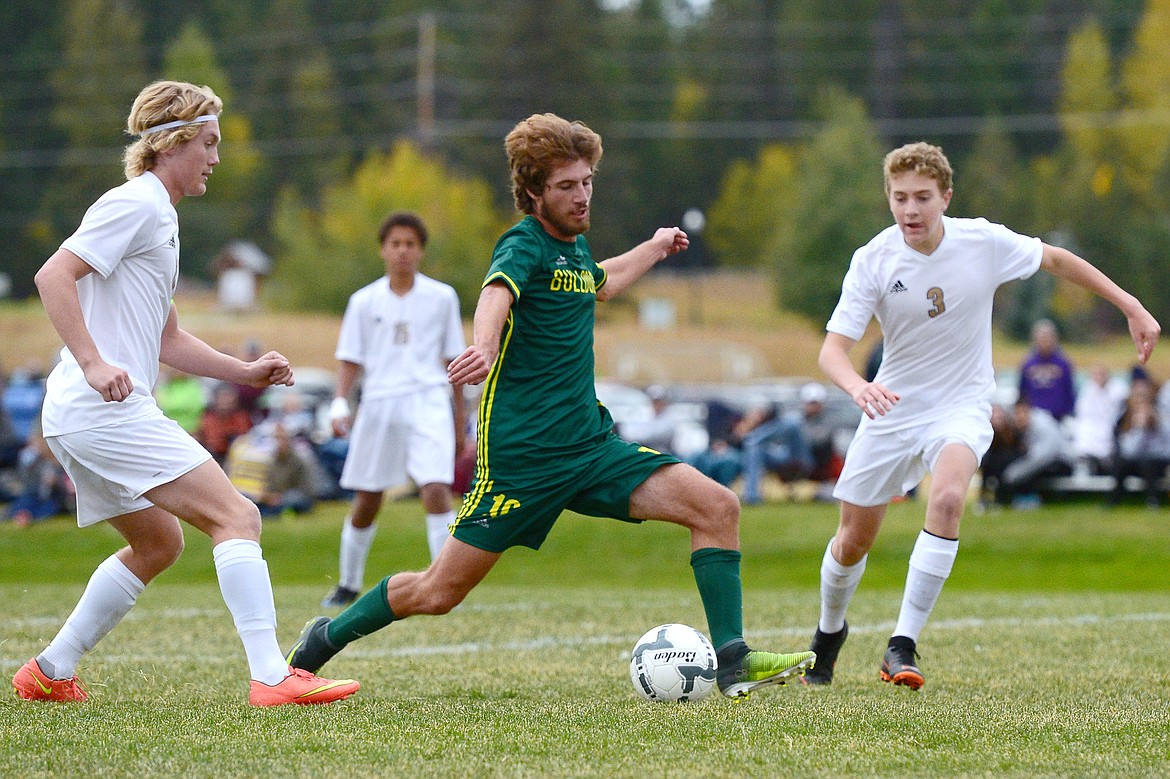 Whitefish's Xander Burger looks for a shot between Polson's Bridger Wenzel (10) and Nico River (3) at Smith Fields in Whitefish on Saturday. (Casey Kreider/Daily Inter Lake)