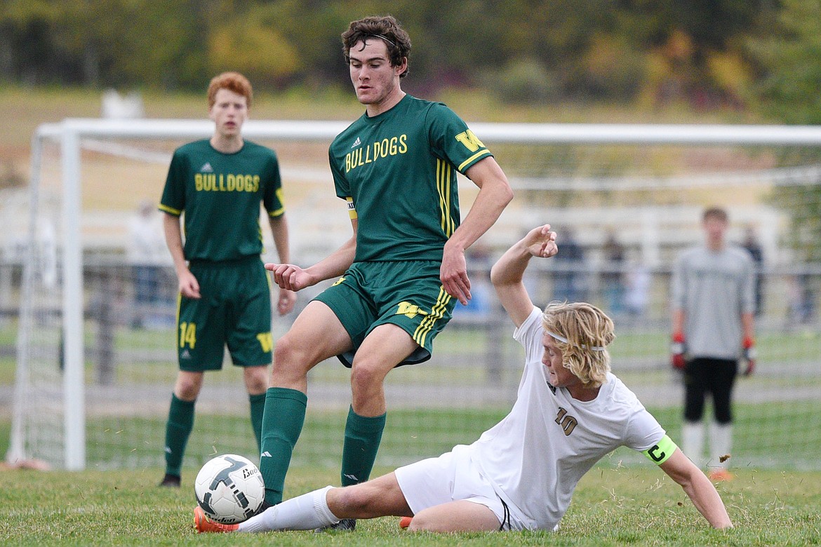 Polson's Bridger Wenzel (10) slides in front of Whitefish's Sam Menicke (20) at Smith Fields in Whitefish on Saturday. (Casey Kreider/Daily Inter Lake)