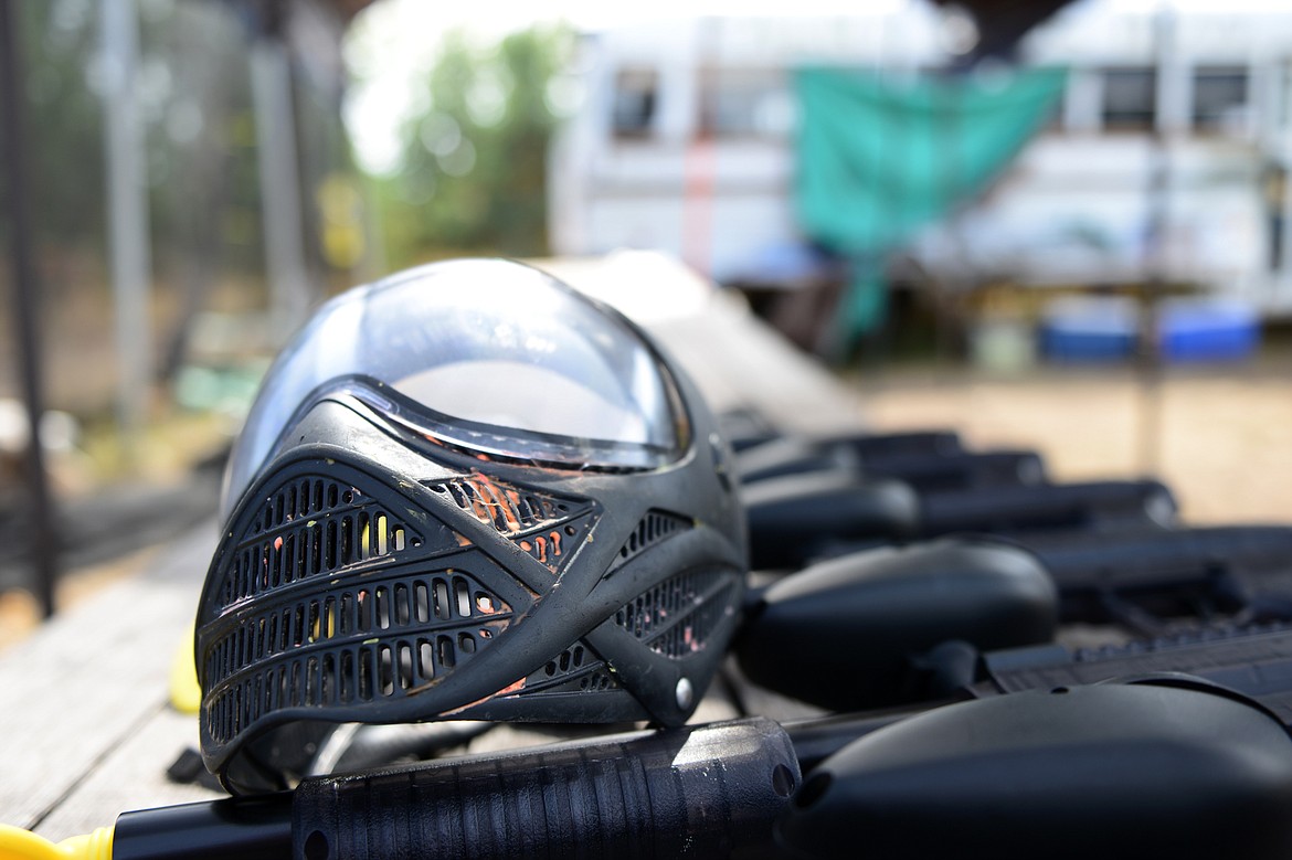 A paint-splattered mask sits next to pump-action, low-impact paintball guns outside Montana Action Paintball on Wednesday. Owner Nick Lynn offers rental of both regular paintball guns and these low-impact models, which will be used around Halloween when Lynn opens a course that will feature zombies. (Casey Kreider/Daily Inter Lake)