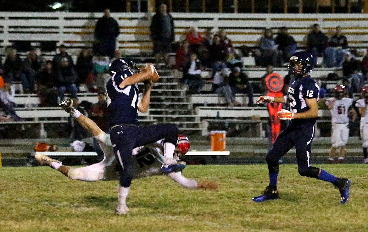 Photos by MANDI BATEMAN
Bonners Ferry defender Ty Bateman (14) battles a Moscow receiver for the ball, then comes down with an interception during the Badgers&#146; Sept. 21 home game against the Bears. Moscow won 49-12. Also defending on the play is Chris Durette (12).