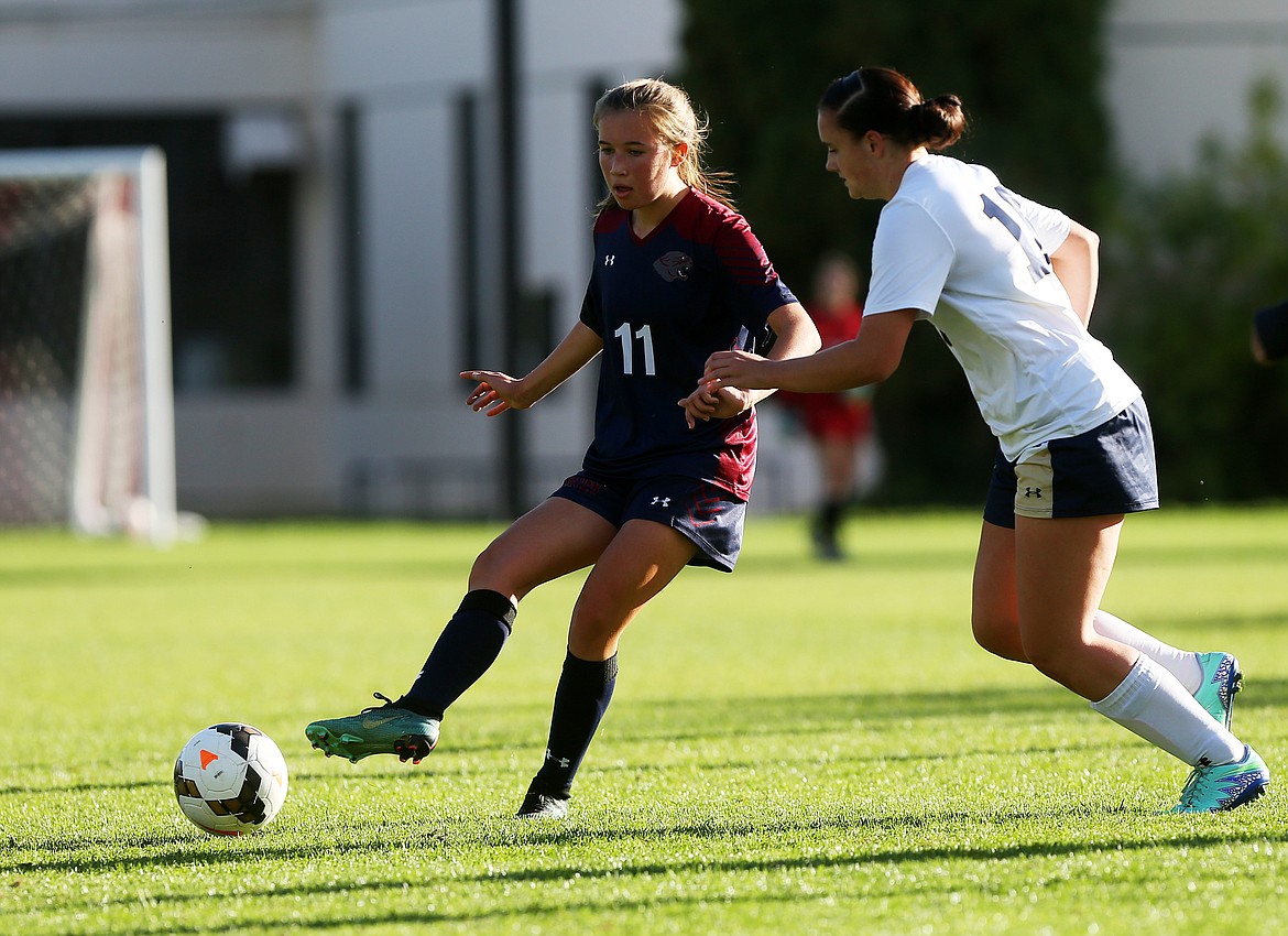 LOREN BENOIT/Press
Coeur d&#146;Alene Charter Academy midfielder Isabella Lucky passes the ball downfield to a teammate as Sadie Anderson of Timberlake High defends during Thursday&#146;s match at North Idaho College. Charter won 1-0.