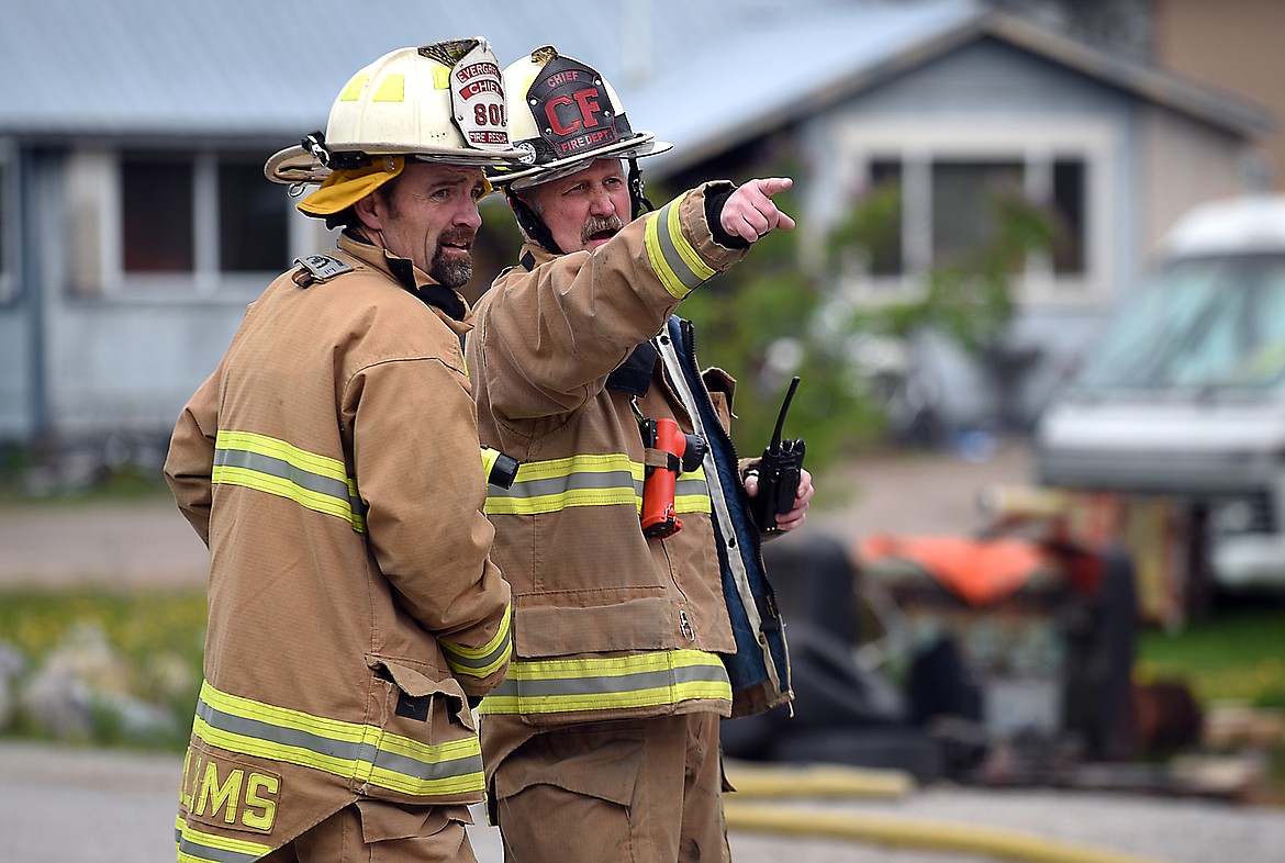 Columbia Falls Fire Chief Rick Hagen, right, and Evergreen Fire Chief Craig Williams at the scene of a fully involved structure fire on Thursday afternoon, May 14, on Brunner Road southwest of Columbia Falls.(Brenda Ahearn/Daily Inter Lake)