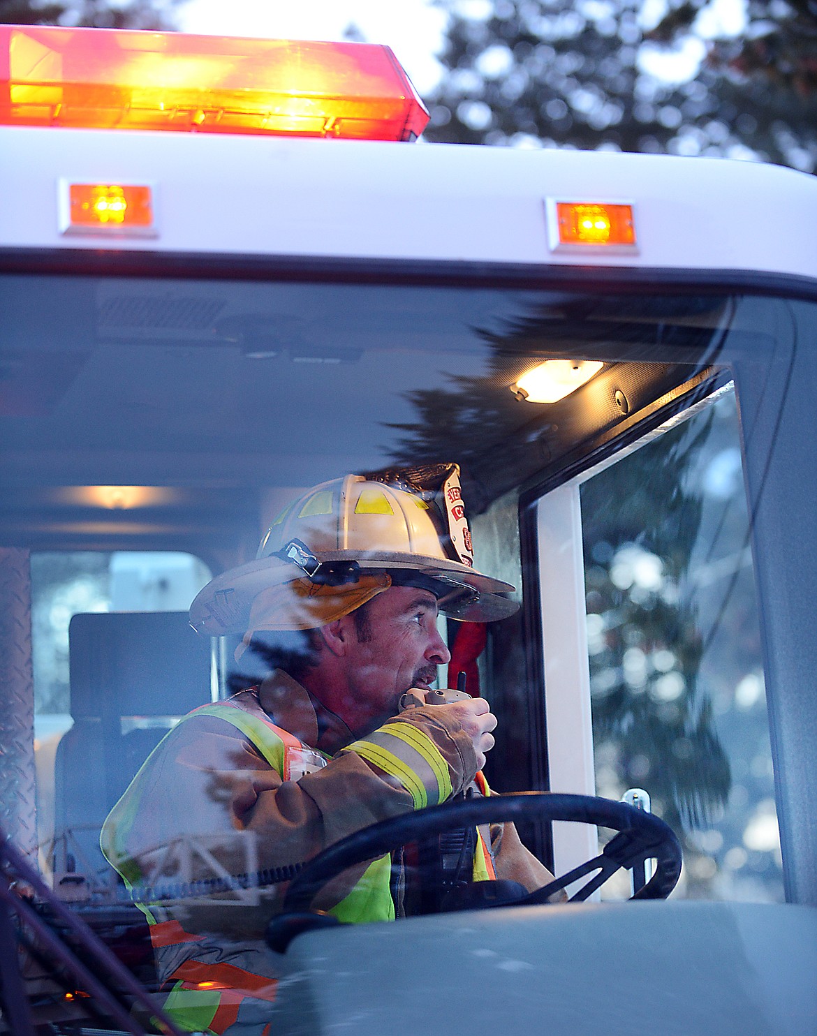 Evergreen Fire Department Chief Craig Williams carefully watches the fire fighters working on a structure fire at 551 Plentywood Drive as they battle a blaze in a garage on Friday night, January 16.(Brenda Ahearn/Daily Inter Lake)