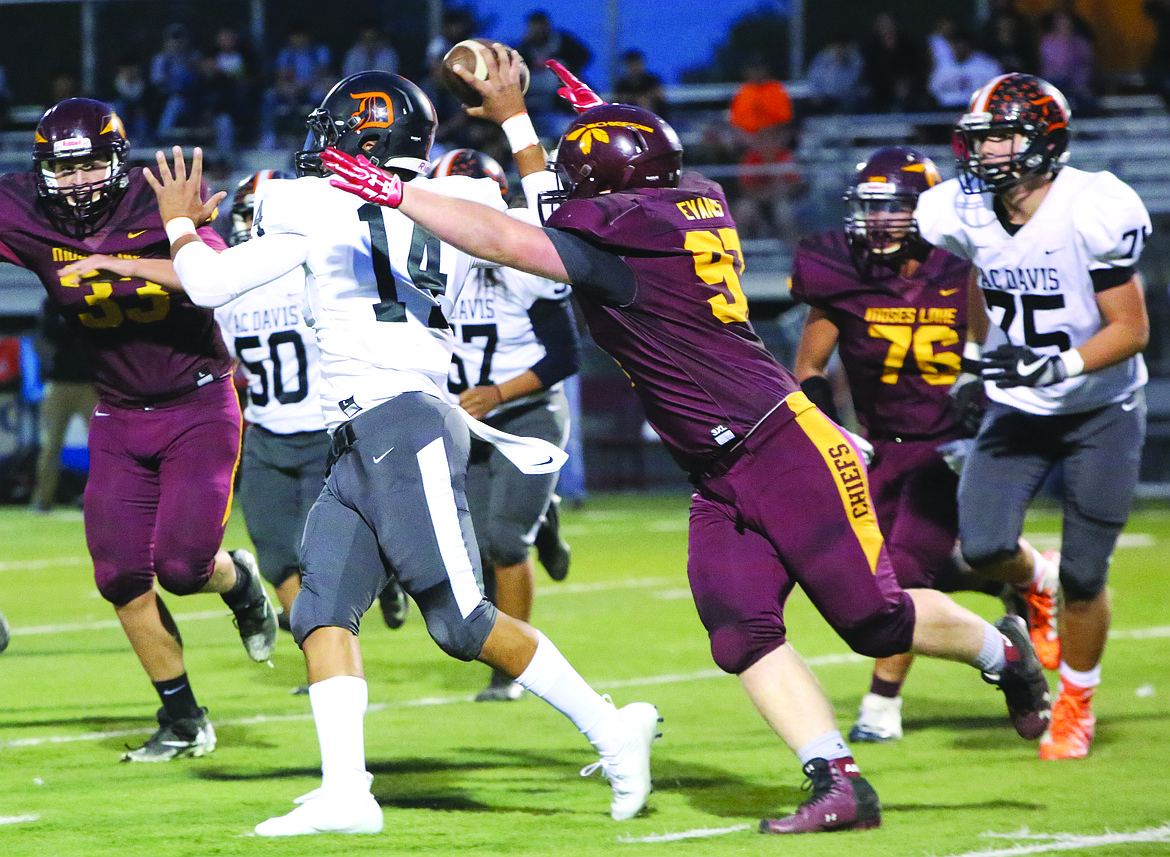 Connor Vanderweyst/Columbia Basin Herald
Moses Lake defensive lineman Carson Evans (right) tackles Davis quarterback Angel Amenzola from behind to force a fumble.