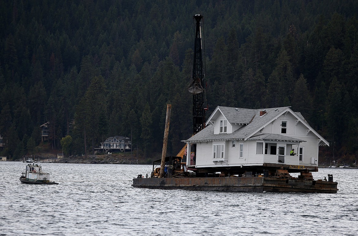 LOREN BENOIT/Press
The &#147;White House&#148; crosses Lake Coeur d&#146;Alene Thursday afternoon to its new location at John Swallow&#146;s property in Casco Bay. The 115-year-old house served various administrative functions for the Village at Orchard Ridge.