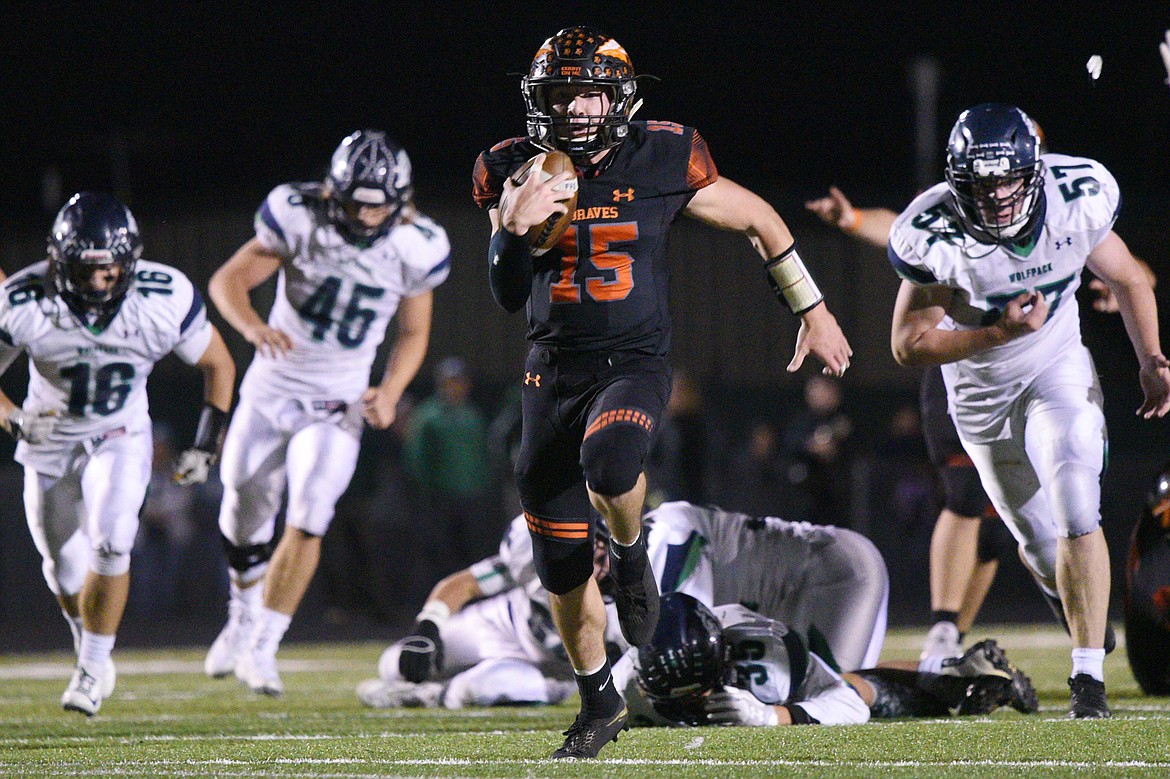 Flathead quarterback Jaden MacNeil (15) heads to the end zone on a 36-yard touchdown run in the third quarter of a crosstown matchup with Glacier at Legends Stadium on Friday. (Casey Kreider/Daily Inter Lake)