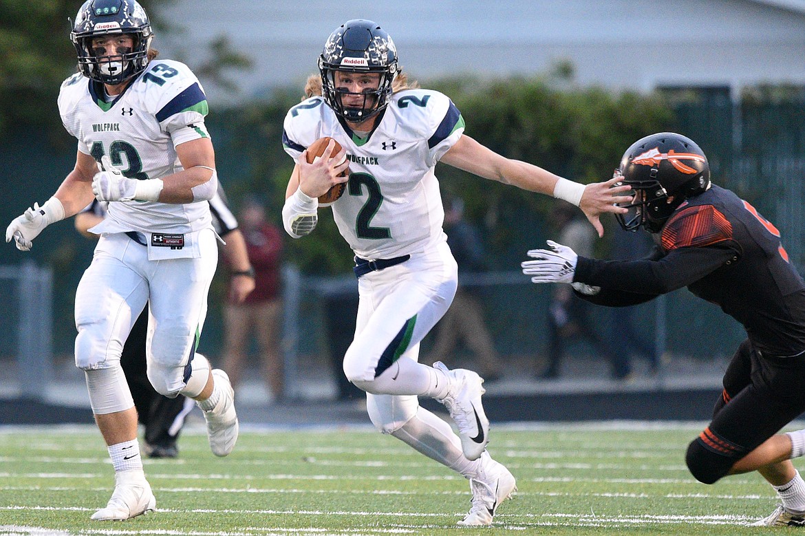 Glacier quarterback Evan Todd (2) looks for room to run in the first quarter against Flathead at Legends Stadium on Friday. (Casey Kreider/Daily Inter Lake)