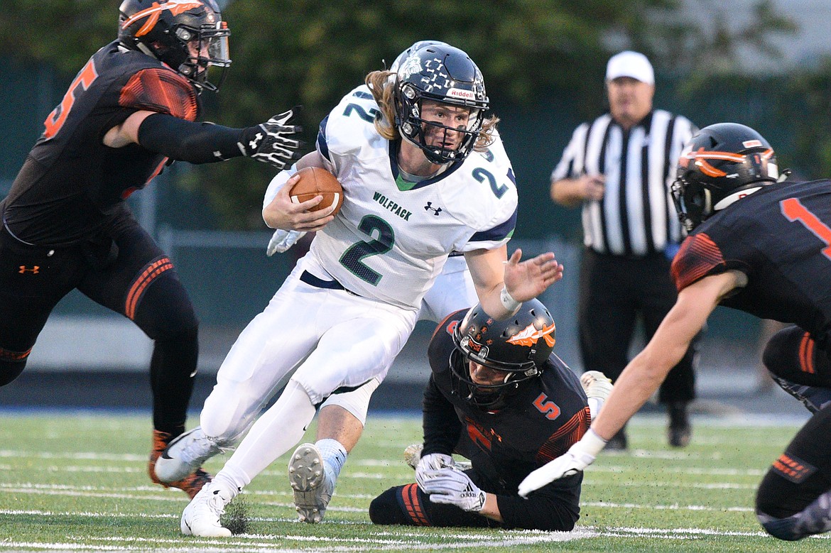 Glacier quarterback Evan Todd (2) looks for room to run in the first quarter against Flathead at Legends Stadium on Friday. (Casey Kreider/Daily Inter Lake)