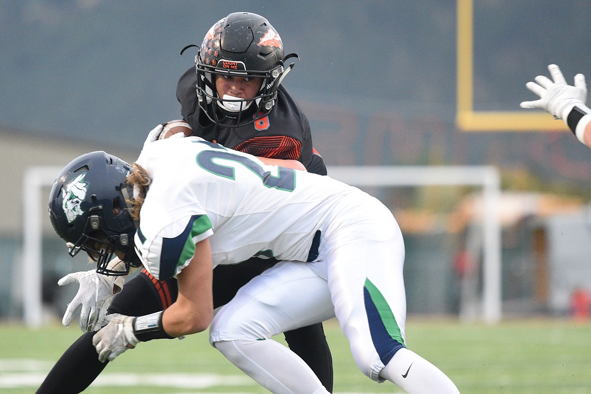 Flathead wide receiver AJ Jones (8) sheds a tackle by Glacier's Casey Peiffer (21) on a first quarter reception at Legends Stadium on Friday. (Casey Kreider/Daily Inter Lake)